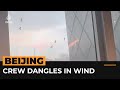 High winds leave crew dangling from Beijing skyscraper | #AJshorts